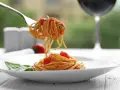 Widok na talerz z makaronem spaghetti i pomidorkami, idealny do rozważań, jakie wino do carbonary.