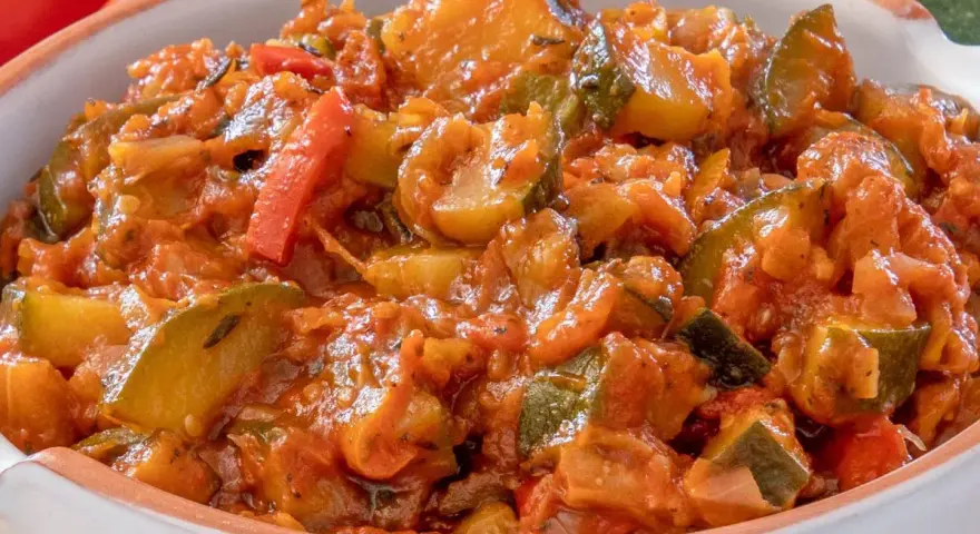 Pyszny bigos z cukinii, pomidorów i papryki, duszony w aromatycznym sosie. Idealny na letni obiad.