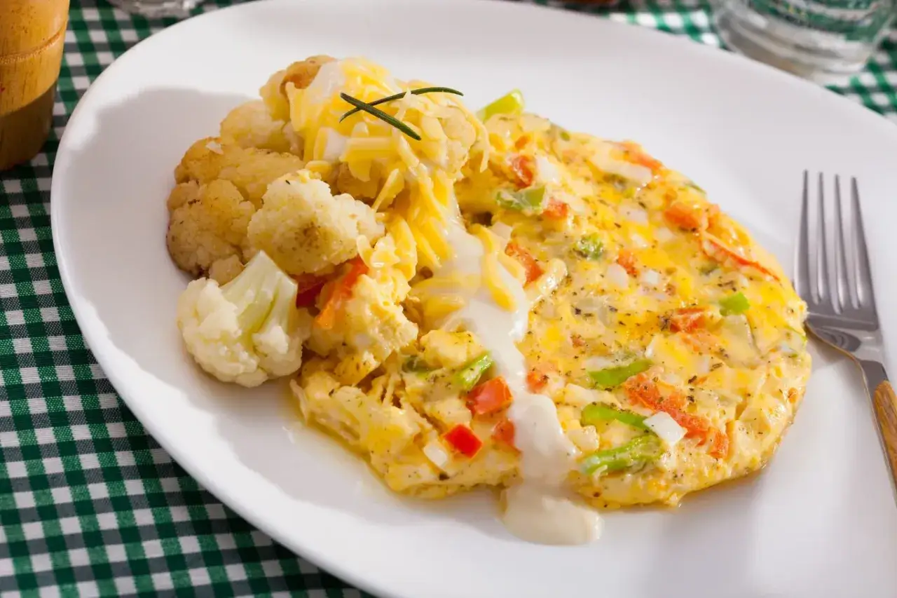 Pyszny omlet z warzywami i serem, podany z kalafiorem. Świetny pomysł, co zrobić z białek, gdy masz ochotę na coś lekkiego i sycącego.